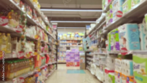 Blurred and trolley moving through product shelf within supermarket