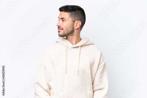Young caucasian man isolated on white background looking to the side © luismolinero