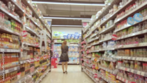 Wallpaper Mural Blurred and trolley moving through people and product shelf within supermarket Torontodigital.ca