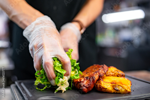 woman chef hand cooking grilled pork neck with baked potatoes and salad