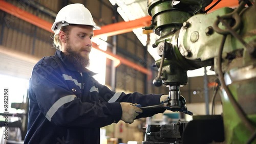 Worker operating in manual lathe.   industrial Engineer manager man demonstration and training mechanic worker woman operating industrial lathe machine and checking quality control