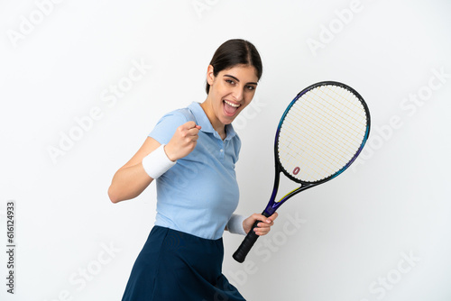 Young caucasian woman isolated on white background playing tennis and celebrating a victory © luismolinero