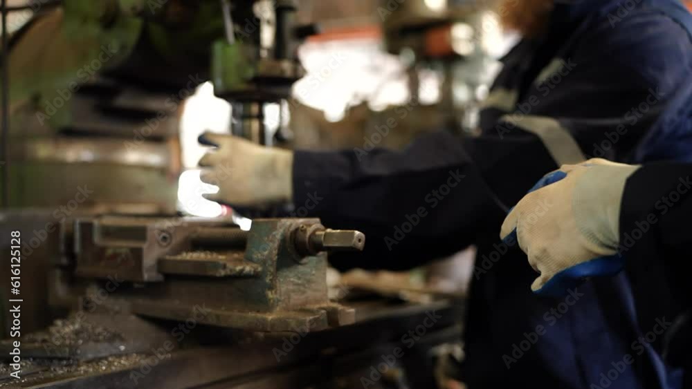 Worker operating in manual lathe. industrial Engineer manager man demonstration and training mechanic worker woman operating industrial lathe machine and checking quality control Worker operating in manual lathe. industrial Engineer manager man demonstration and training mechanic worker woman operating industrial lathe machine and checking quality control