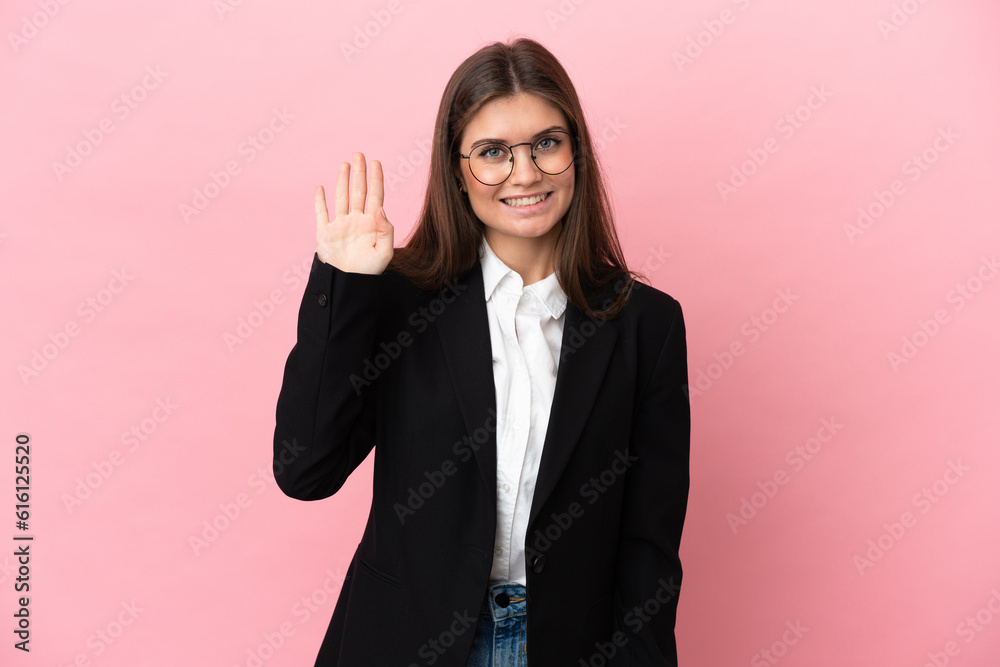 Young Business caucasian woman isolated on pink background saluting with hand with happy expression Young Business caucasian woman isolated on pink background saluting with hand with happy expression