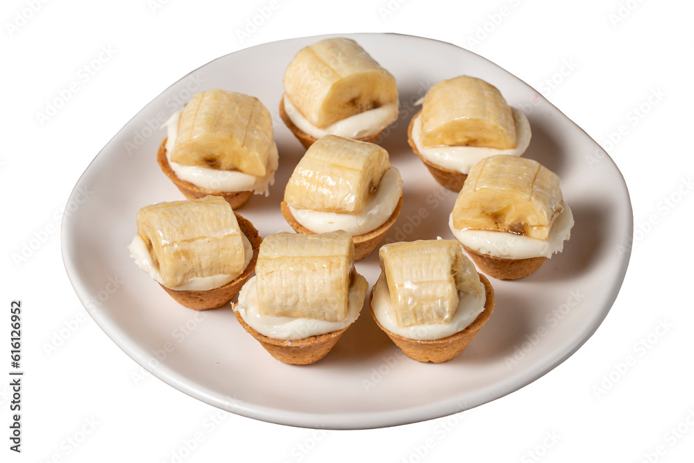 Banana tartlet isolated on white background. Delicious tartlet dessert on plate. close up Banana tartlet isolated on white background. Delicious tartlet dessert on plate. close up