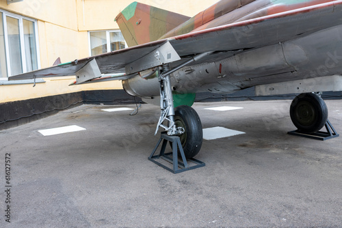 Aircraft landing gear in military coloring at a military base in the city.