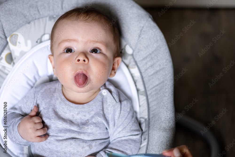 cute adorable boy child eating food from jar mashed puree.mother woman
