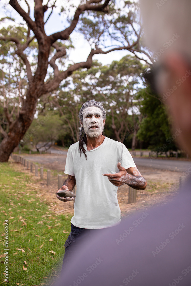 Aboriginal man in green bush surrounds telling stories Aboriginal man in green bush surrounds telling stories