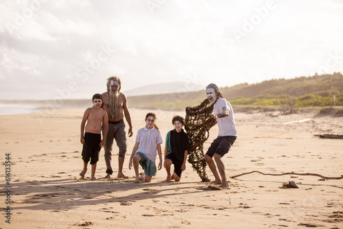 Aboriginal mob at the beach looking at camera focus on foreground photo
