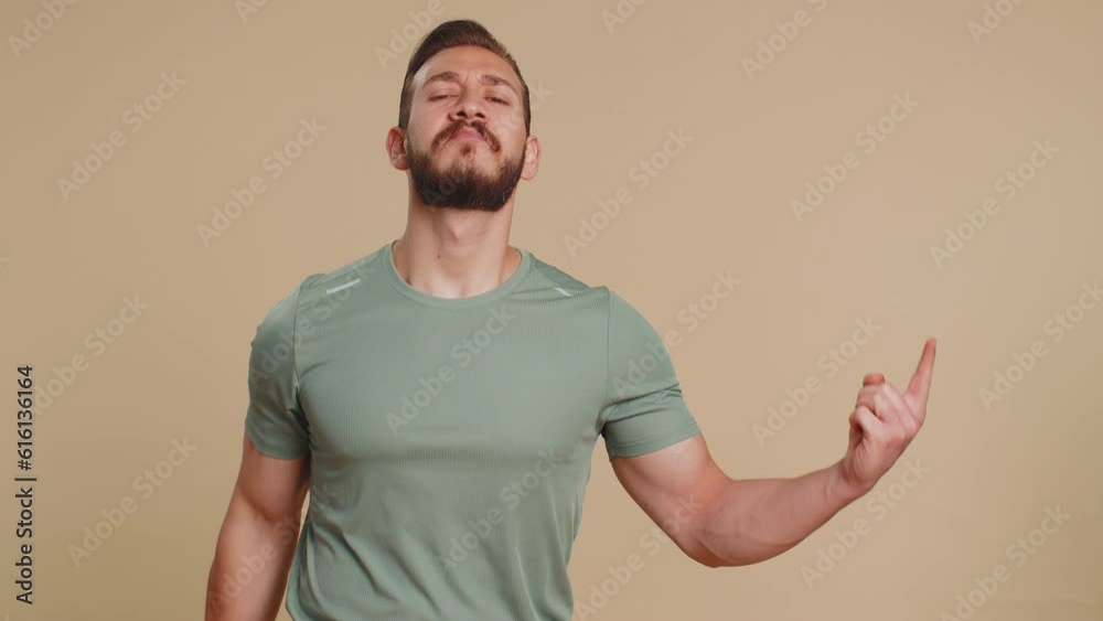 Athlete man showing pointing empty place, advertising area for commercial text, copy space for goods promotion, recommendation. Middle eastern sportsman guy weightlifting dumbbell on beige background Athlete man showing pointing empty place, advertising area for commercial text, copy space for goods promotion, recommendation. Middle eastern sportsman guy weightlifting dumbbell on beige background