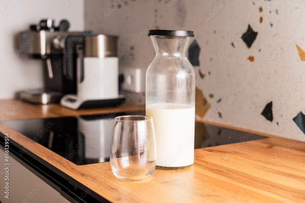 A glass jar with milk and a cup
A glass jar with milk and a cup