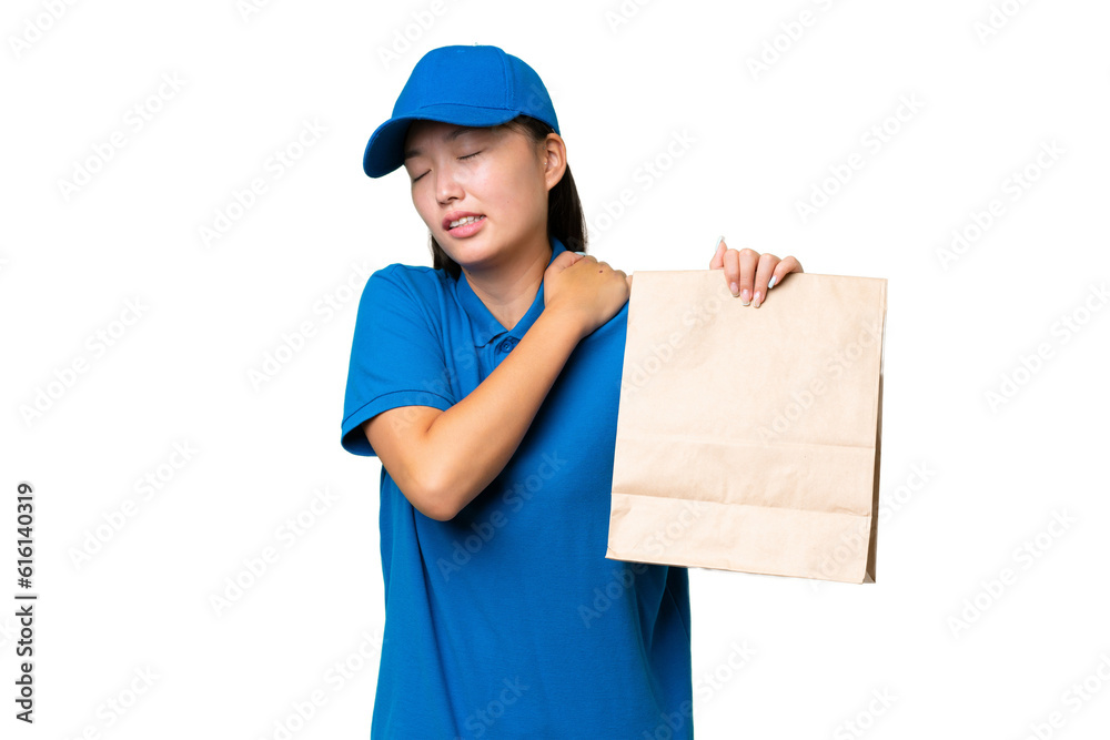 Young Asian woman taking a bag of takeaway food over isolated background suffering from pain in shoulder for having made an effort Young Asian woman taking a bag of takeaway food over isolated background suffering from pain in shoulder for having made an effort