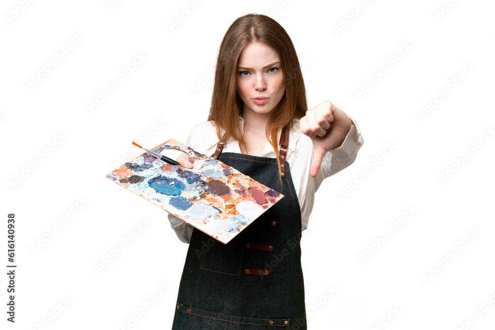 Young artist woman holding a palette over isolated chroma key background showing thumb down with negative expression Young artist woman holding a palette over isolated chroma key background showing thumb down with negative expression
