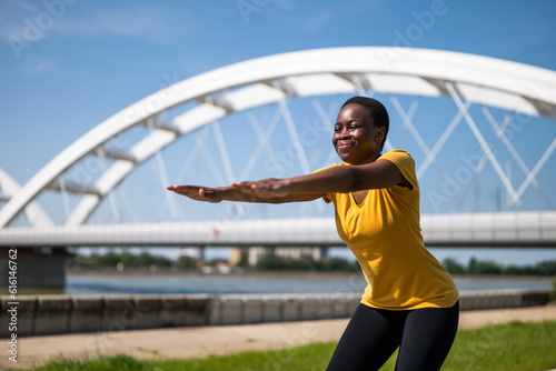 Young woman enjoys exercising outdoor © inesbazdar