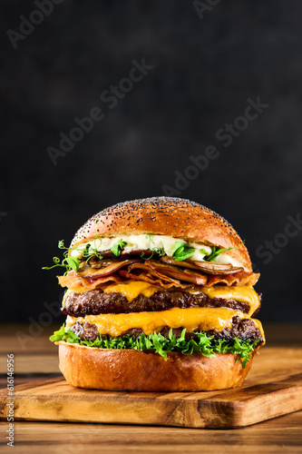 Double burger with cheese, salad, bacon and mushrooms. Double hamburger, cheeseburger