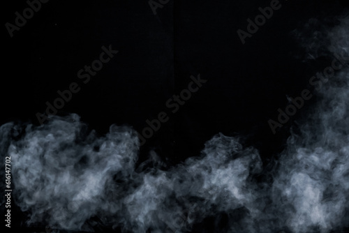 smoke spray fog mist motion air pattern on black background space for text for Halloween card template invitation flyer