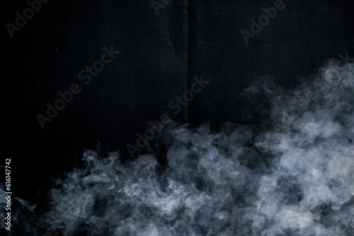 smoke spray fog mist motion air pattern on black background space for text for Halloween card template invitation flyer