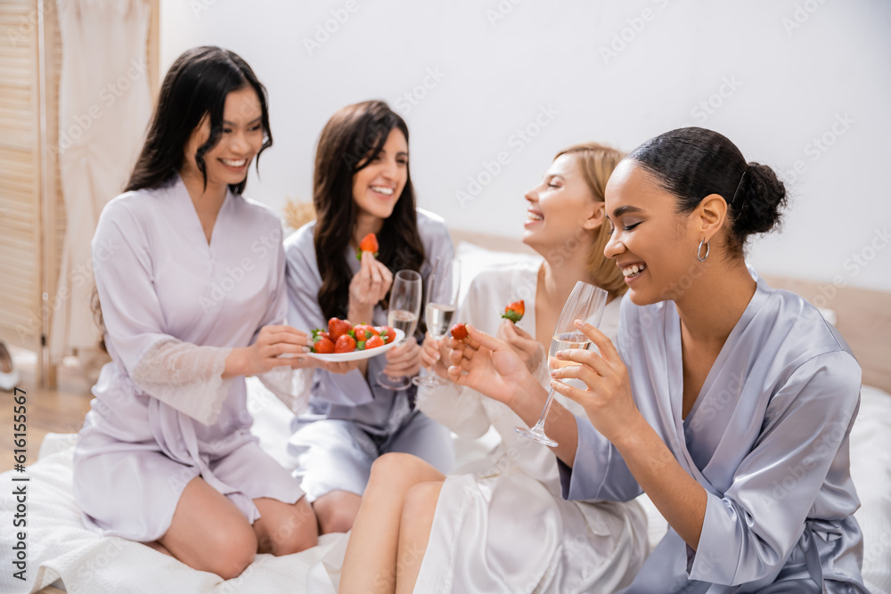 bridal party, strawberries and champagne, four women, multicultural girlfriends having fun, brunette and blonde, bride and her bridesmaids spending time together, cultural diversity, bedroom bridal party, strawberries and champagne, four women, multicultural girlfriends having fun, brunette and blonde, bride and her bridesmaids spending time together, cultural diversity, bedroom