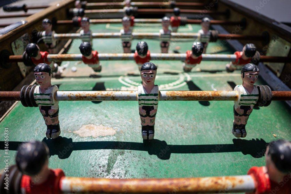 Vintage foosball table displaying Sport Lisboa e Benfica and Sporting