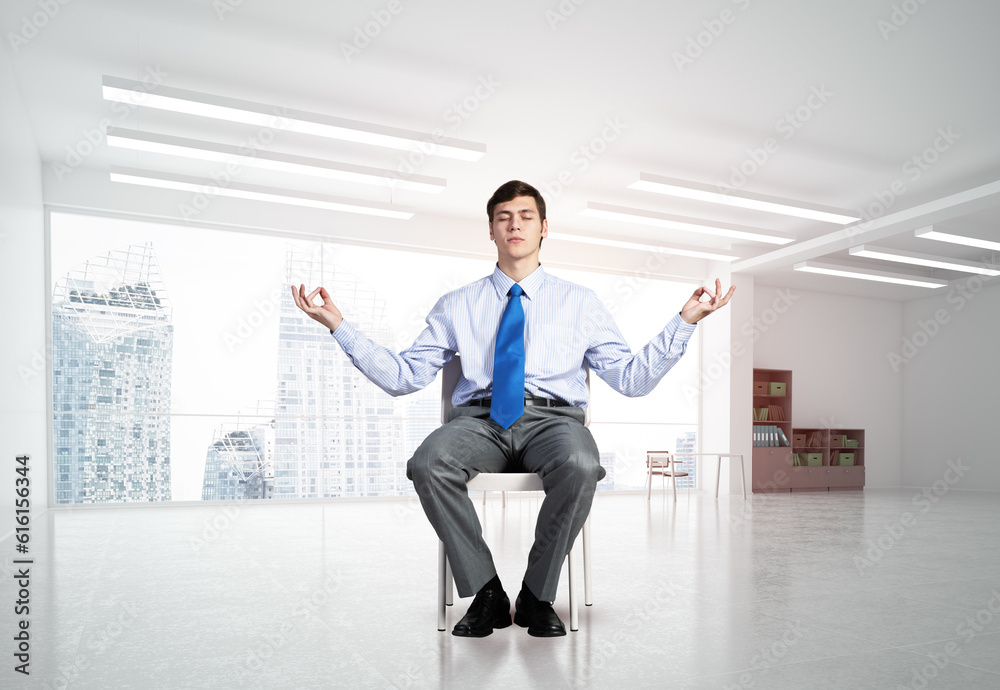 young businessman meditating in the office young businessman meditating in the office
