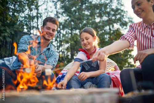 Fireside Bonding: Family Fun with Marshmallows and the American Flag © luckybusiness