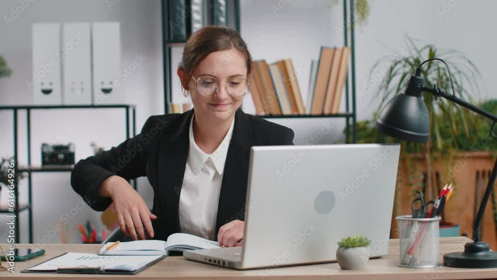 Happy relaxed overjoyed Caucasian business woman working on laptop computer at office wearing headphones listening favorite energetic disco music and dancing. Freelancer girl relaxing, taking a break