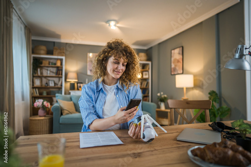 adult caucasian woman adjust prepare home surveillance security camera