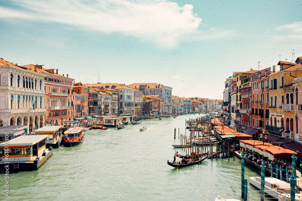 breathtaking beauty of Venice, Italy with an amazing view of the city. Delight in the enchanting sight of numerous gondolas gracefully sailing down one of the picturesque canals.
