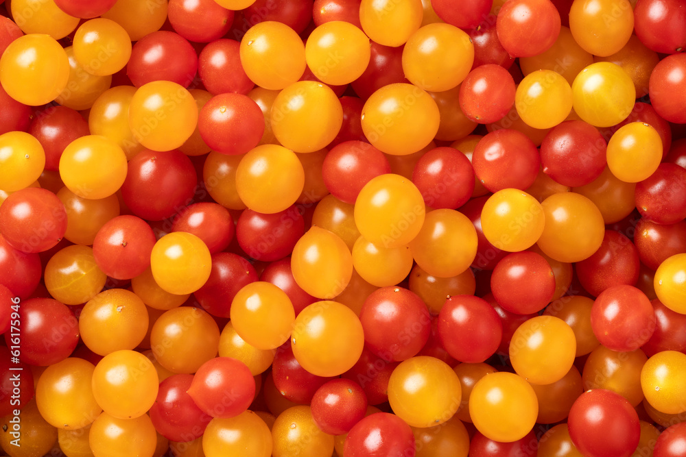 Red and yellow Tomberry tomatoes close up full frame as background Red and yellow Tomberry tomatoes close up full frame as background