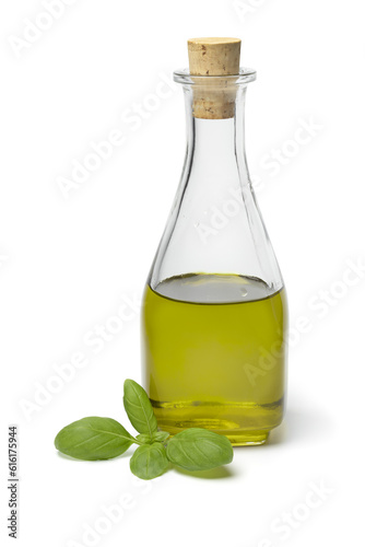 Glass bottle with homemade basil oil close up isolated on white background