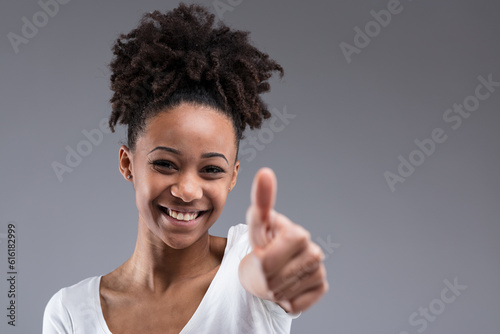 Woman with afro, thumbs up, positivity
