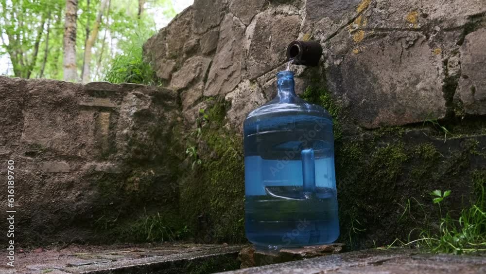 Bottle with fresh cold natural spring water from source Bottle with fresh cold natural spring water from source