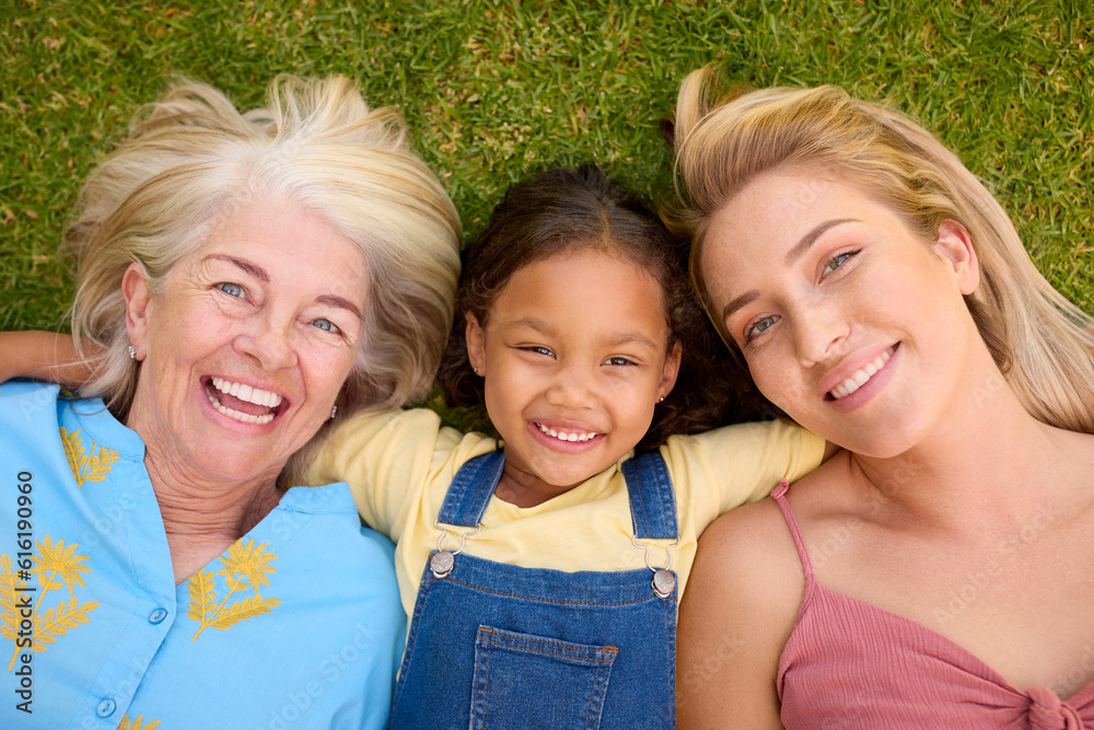 Overhead Shot Of Multi-Generation Female Family Lying On Grass Togther Overhead Shot Of Multi-Generation Female Family Lying On Grass Togther
