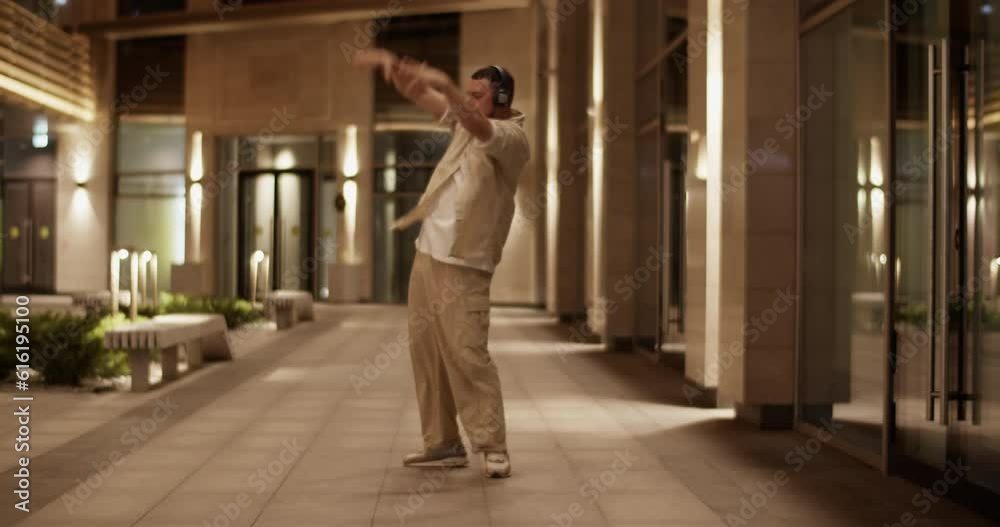 Energetic freestyle dancer performing on street Energetic freestyle dancer performing on street