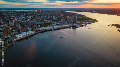 Aerial Drone Fly Above Asuncion City Waterfront in Paraguay, Daylight Cityscape Panorama of South American River © Michele