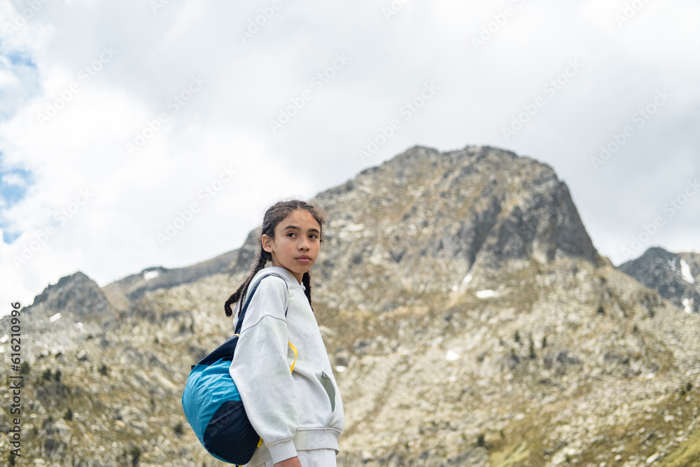 mountaineer boy with a backpack, and serious long hair