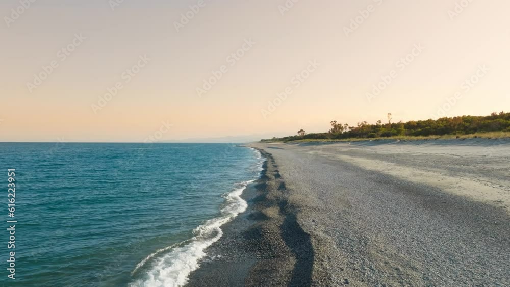 Tropical beach at sunset near a flat empty ocean Tropical beach at sunset near a flat empty ocean