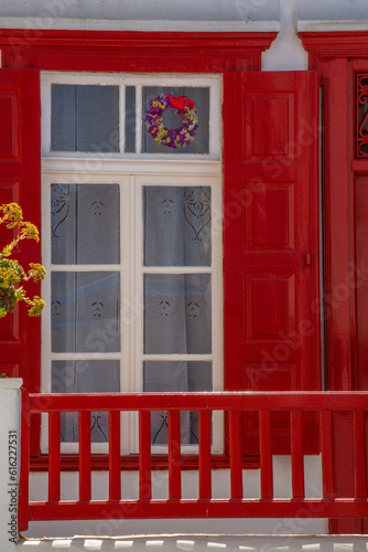 Old  red  wooden door of a white traditional house in Cyclades  Greece.