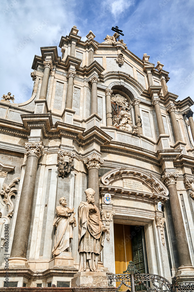 Fototapeta premium Columns and statues of the Baroque facade of the Cathedral Basilica of St. Agates in the city of Catania, on the island of Sicily
