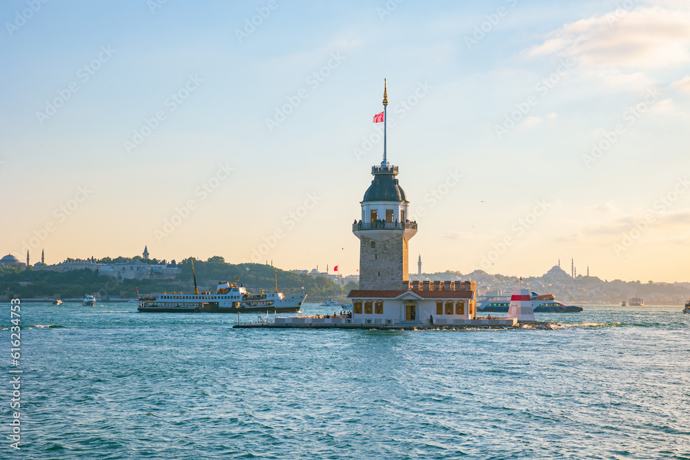 Istanbul background photo. Kiz Kulesi or Maiden's Tower and ferry at sunset