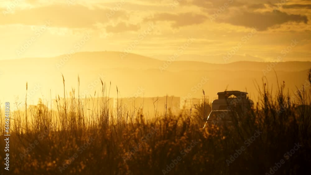 Coastal sunset landscape with caravan trailer wild camping on beach. Capi Corb, Mediterranean coast of Spain. Holidays, traveling with motorhome. Coastal sunset landscape with caravan trailer wild camping on beach. Capi Corb, Mediterranean coast of Spain. Holidays, traveling with motorhome.