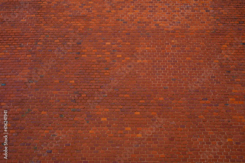 Big brick wall made of orange and red bricks as part of outer wall of Wawel castle in Krakow, poland. Frontal View
