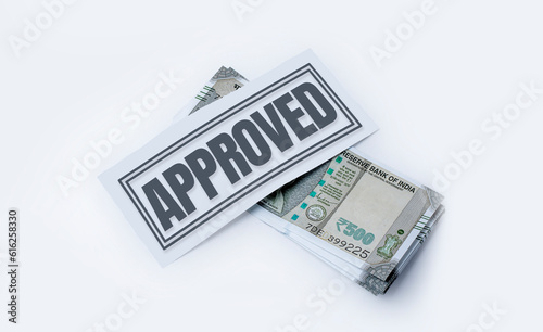 Business Loan Approved Concept: Money Isolated on White Background with Approval Stamp in the Middle. Indian currency, 500 hundred rupee notes