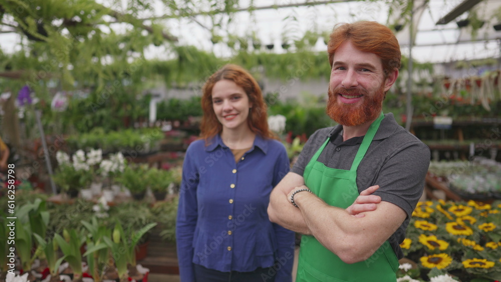 Joyful Female Customer and Confident Male Florist in Green Apron at Flower Shop Joyful Female Customer and Confident Male Florist in Green Apron at Flower Shop