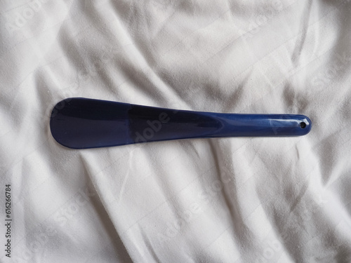 shoehorn on bed sheet photo