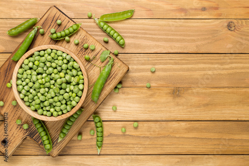 Composition with fresh green peas on wooden background, top view