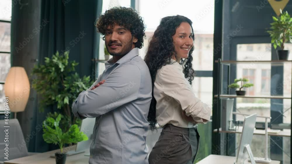 Two business partners multiracial colleagues Arabian man businessman and Hispanic woman businesswoman posing arms crossed in office diverse managers team leaders happy smiling partnership cooperation Two business partners multiracial colleagues Arabian man businessman and Hispanic woman businesswoman posing arms crossed in office diverse managers team leaders happy smiling partnership cooperation