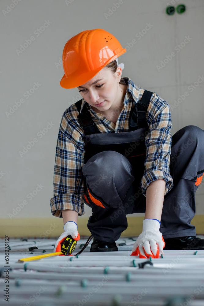 Worker is installing underfloor heating system. Warm floor heating system Worker is installing underfloor heating system. Warm floor heating system