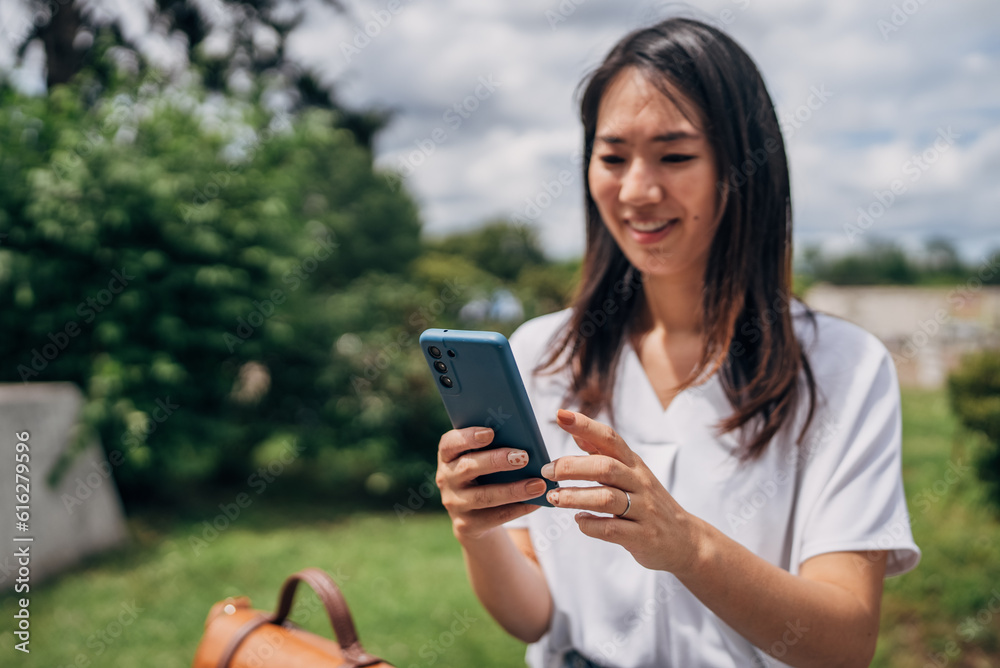 Young Japanese woman using smart phone in the city
Young Japanese woman using smart phone in the city