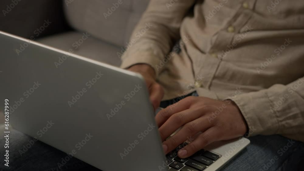 Concentrated Arabian muslim businessman male freelancer typing computer keyboard working from home on couch shopping online with laptop at kitchen apartment Indian man guy business work on quarantine Concentrated Arabian muslim businessman male freelancer typing computer keyboard working from home on couch shopping online with laptop at kitchen apartment Indian man guy business work on quarantine